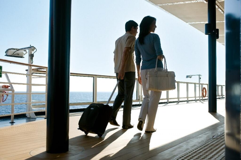 Couple carrying luggage on a cruise